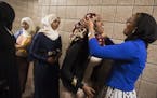 From right, Augsburg students Aisha Barre, 19, and Anisa Ahmed, 18, primped backstage before Wednesday&#x2019;s Hijab Fashion Show.