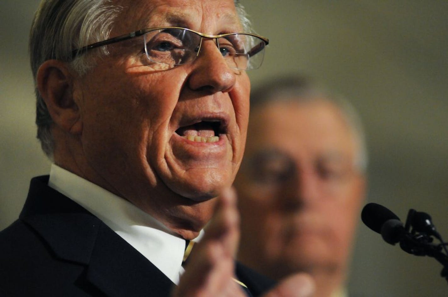 Former Minnesota Gov. Arne Carlson with former Vice President Walter Mondale in background