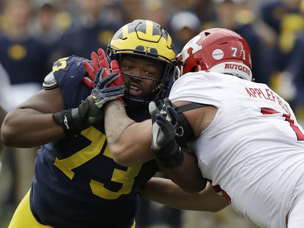Michigan defensive lineman Maurice Hurst (73) goes up against Rutgers offensive lineman Marcus Applefield (71) during the second half of an NCAA colle