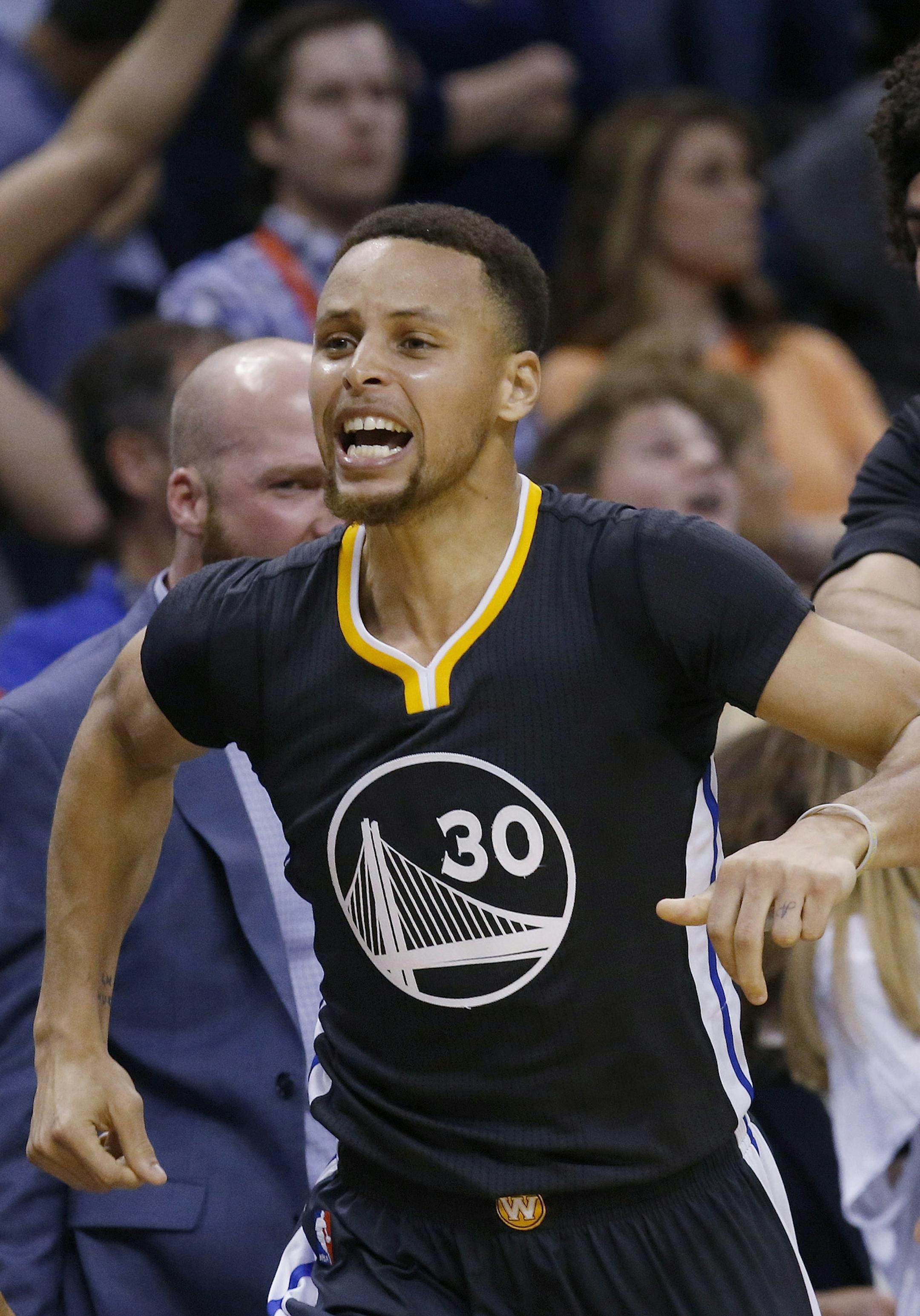 Golden State Warriors guard Stephen Curry (30) celebrates with teammate Anderson Varejao, right, after hitting the game-winning shot in overtime of an NBA basketball game against the Oklahoma City Thunder in Oklahoma City, Saturday, Feb. 27, 2016. Golden State won 121-118. (AP Photo/Sue Ogrocki)