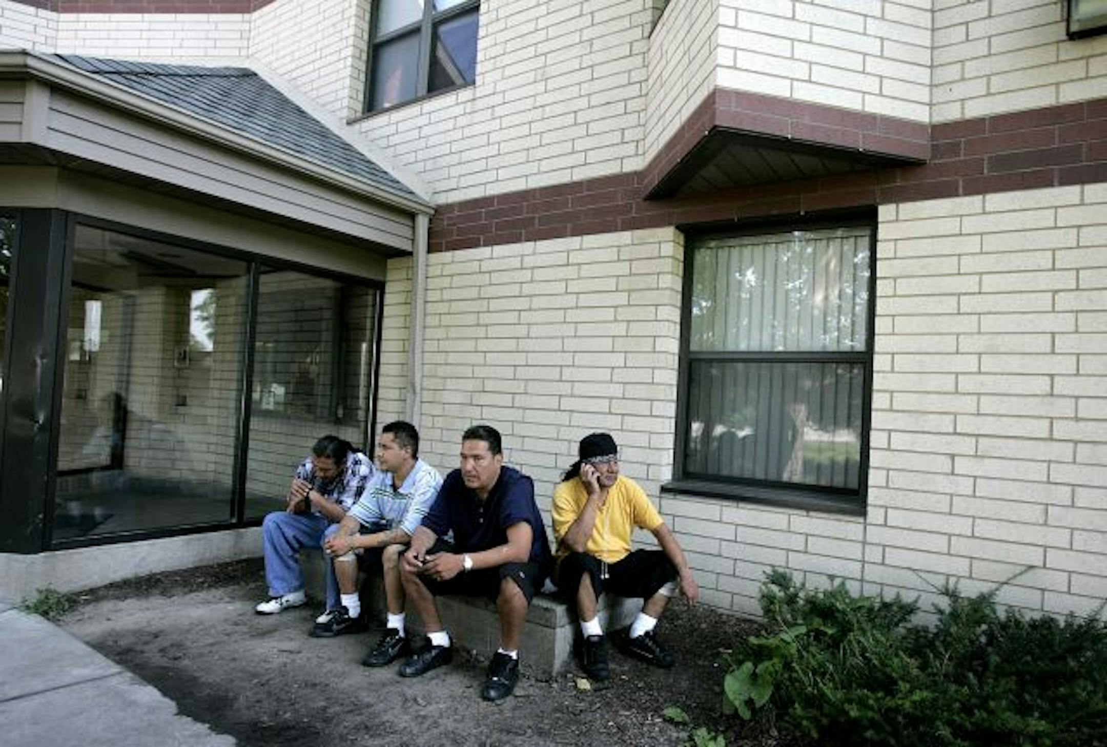 David Charging Whirl wind, left to right, Norman Bates, Herb Sam and Cecil Little Eagle socialize outside Anishinabe Wakiagun, a "wet house" treatment facility for chronic alcoholics that permits them to continue drinking, where Charging Whirl Wind and Sam live. Since coming to the facility Charging Whirl Wind and Sam have both stopped drinking alcohol. "When I'm on the street I don't give a @#@#," Charging Whirl Wind said. "I'll fight anybody. I don't care." Sam said: "Since I've been here I've