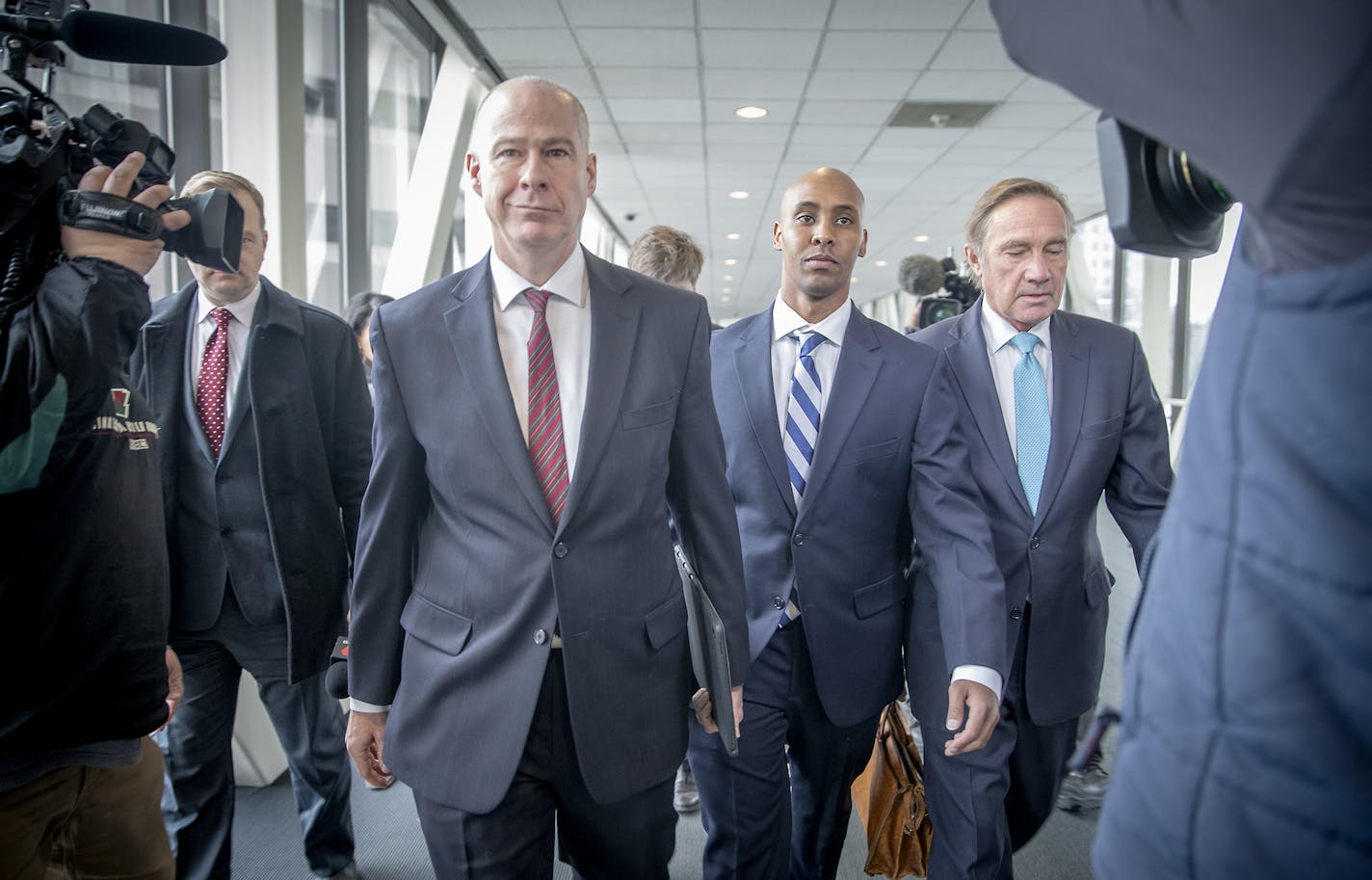 Mohamed Noor, center, left the Hennepin County Government Center flanked by his attorneys, Thomas Plunkett, left, and Peter Wold, right, after a pretrial motions hearing, Friday, March 1, 2019 in Minneapolis, MN. ] ELIZABETH FLORES &#x2022; liz.flores@startribune.com