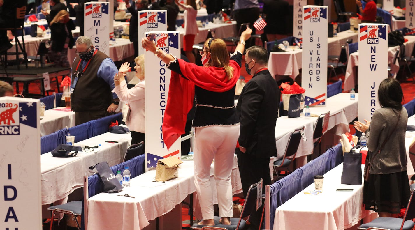 Attendees cheer as President Donald Trump speaks at the Republican National Convention in Charlotte, N.C., Monday afternoon, Aug. 24, 2020. (Travis Dove/The New York Times)