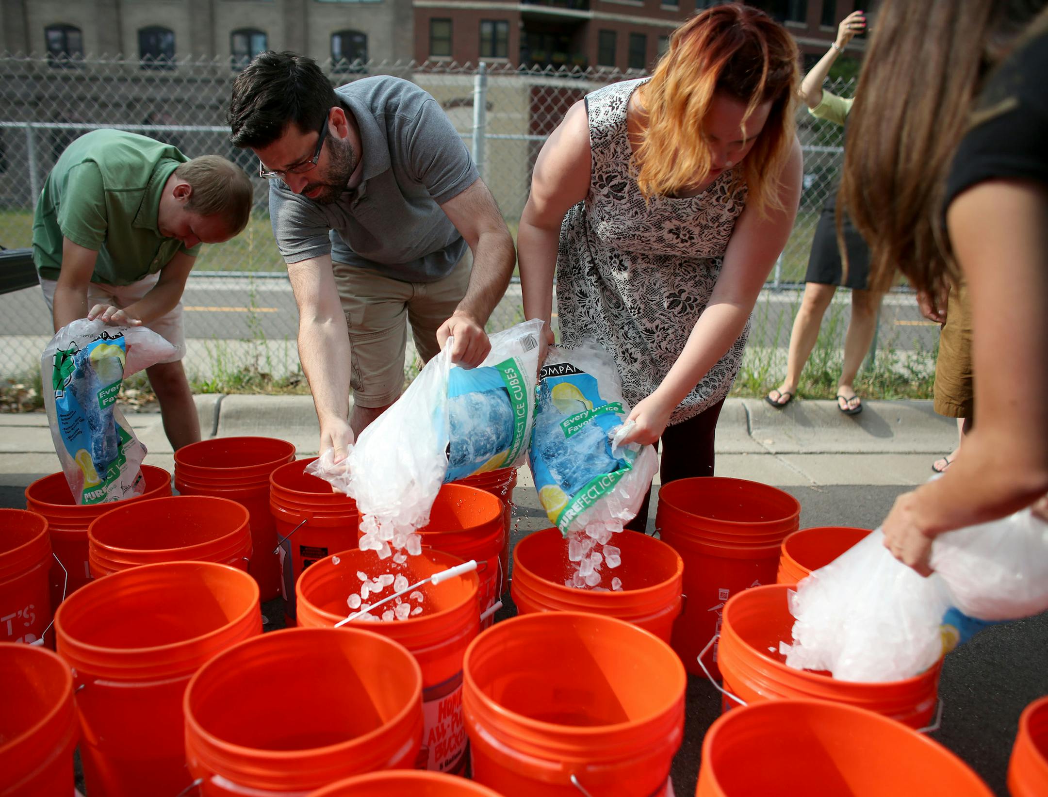 Employees of space150 ad agency, filled up buckets with ice as they prepared for the ice bucket challenge for ALS. ] (KYNDELL HARKNESS/STAR TRIBUNE) kyndell.harkness@startribune.com In a parking lot behind the building that houses space150 ad agency in Minneapolis Min., wednesday, August, 20, 2014. About 20 staff members at space150 ad agency in Minneapolis will be taking on the ice bucket challenge.