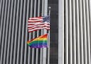 This Wednesday, June 1, 2011 picture shows U.S. and rainbow flags flying at the Federal Reserve Bank building in downtown Richmond, Va. Republican Del