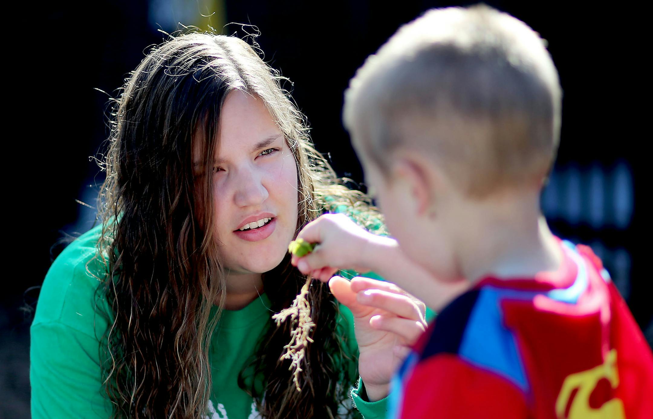 "I knew I was going to have issues. It's something I'll deal with for the rest of my life," said
Katie Helmer, a Minnesota National Guard veteran, shown with one of her charges at a preschool where she teaches.