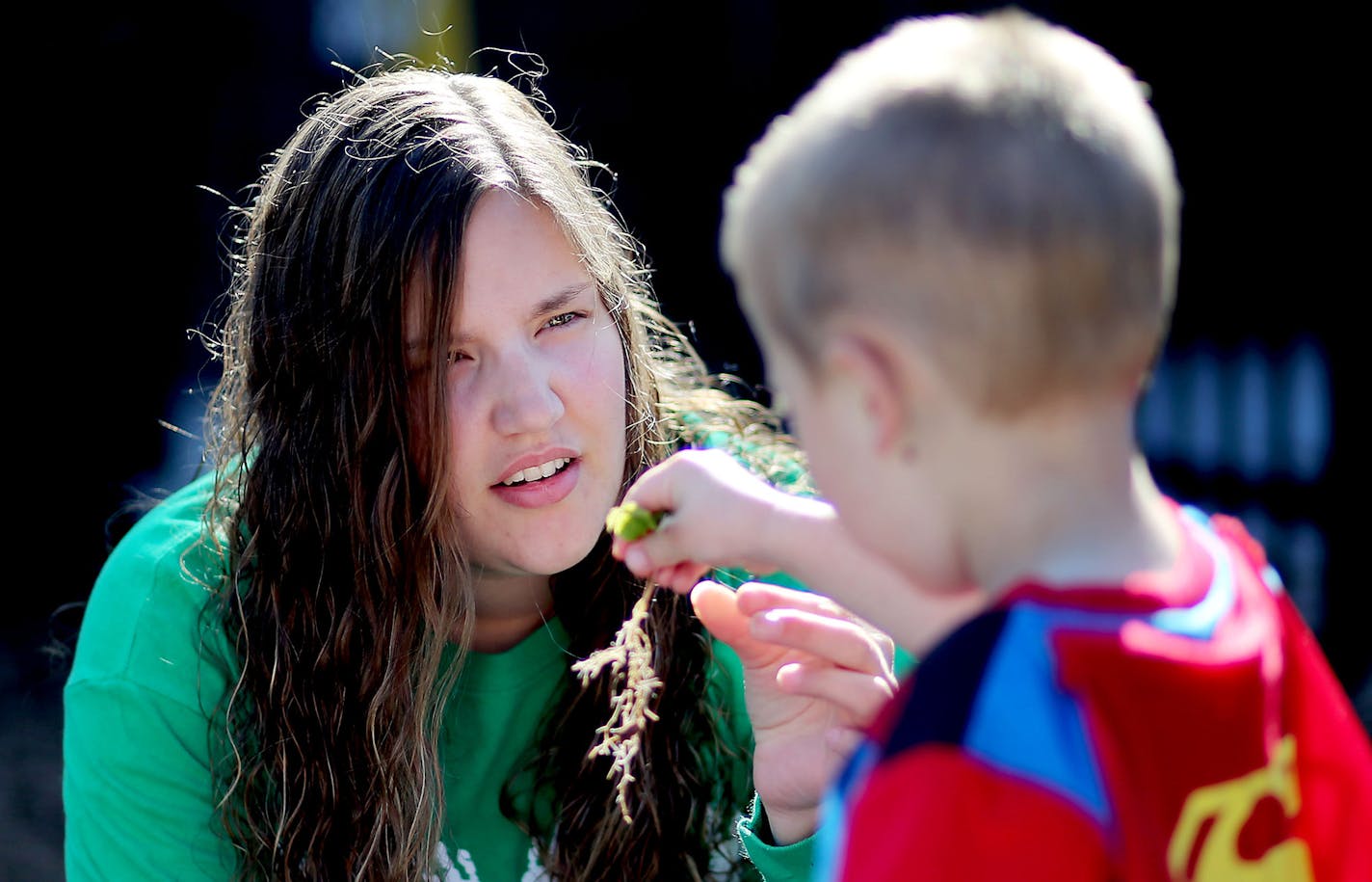 "I knew I was going to have issues. It's something I'll deal with for the rest of my life," said
Katie Helmer, a Minnesota National Guard veteran, shown with one of her charges at a preschool where she teaches.