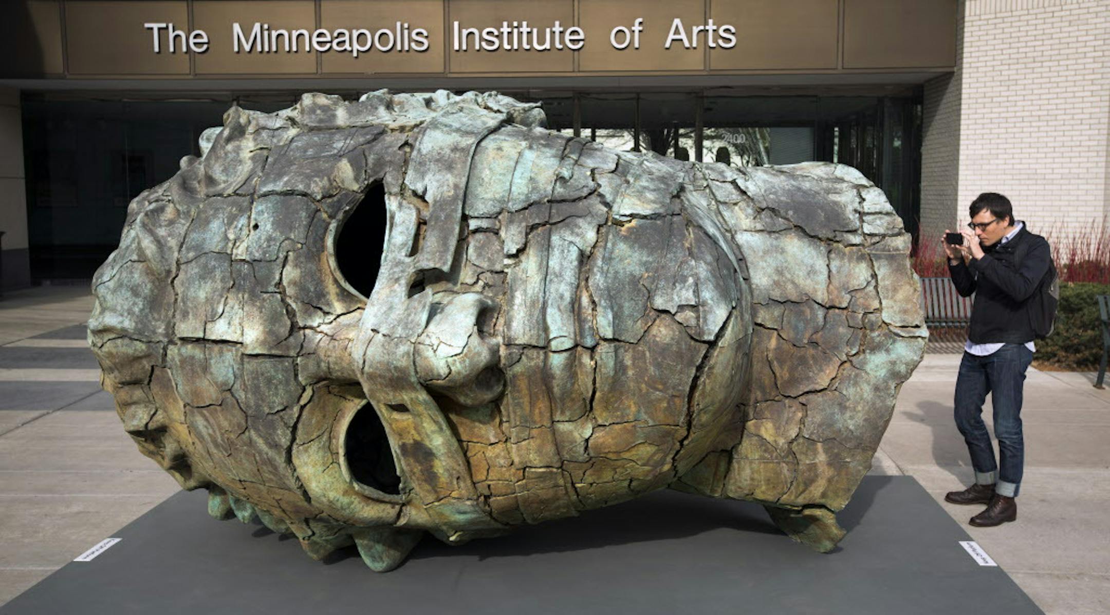 In celebration of the MIA&#xed;s 100th Birthday Year, curators searched for a monumental outdoor sculpture that would reference the museum&#xed;s historic art collections and be a new masterpiece for the community. Eros is sure to become an icon for the museum and Minneapolis. Here, Dylan Thomas, takes a picture outside the main entrance of the MIA. ] Brian.Peterson@startribune.com Minneapolis, MN - 4/28/2015 ORG XMIT: MIN1504281051001398