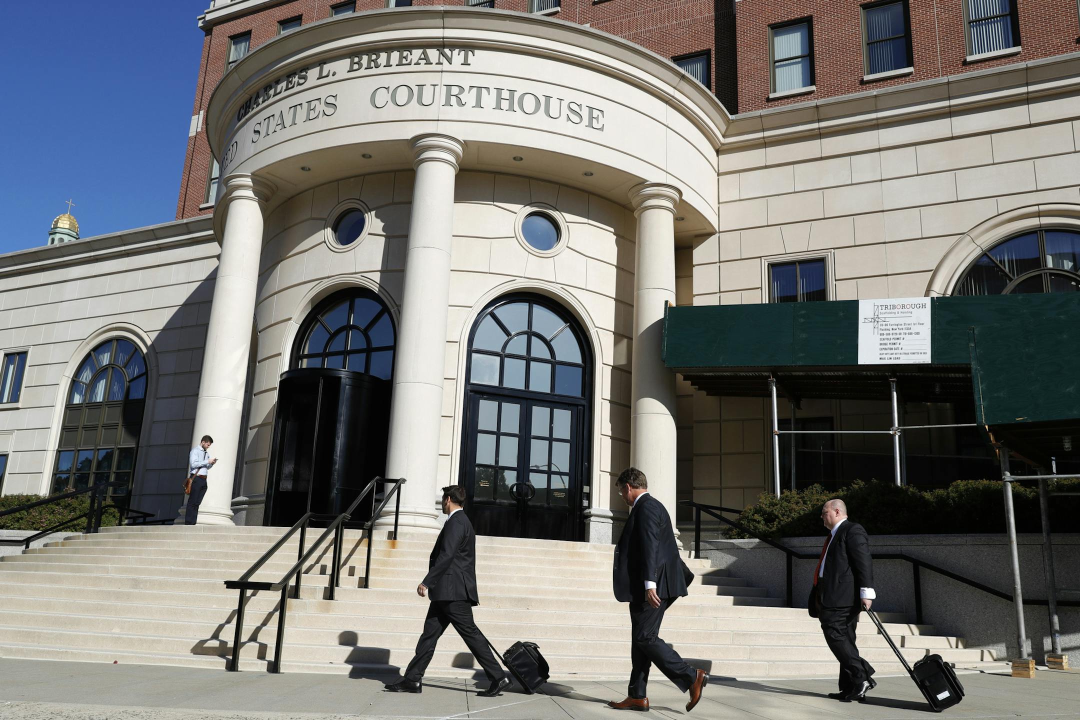 People enter the US District Court in White Plains, N.Y., Tuesday, Sept. 17, 2019. Purdue Pharma gets its day in court Tuesday after the OxyContin maker filed for bankruptcy and negotiated a potential multi-billion dollar settlement to resolve thousands of lawsuits. (AP Photo/Seth Wenig)