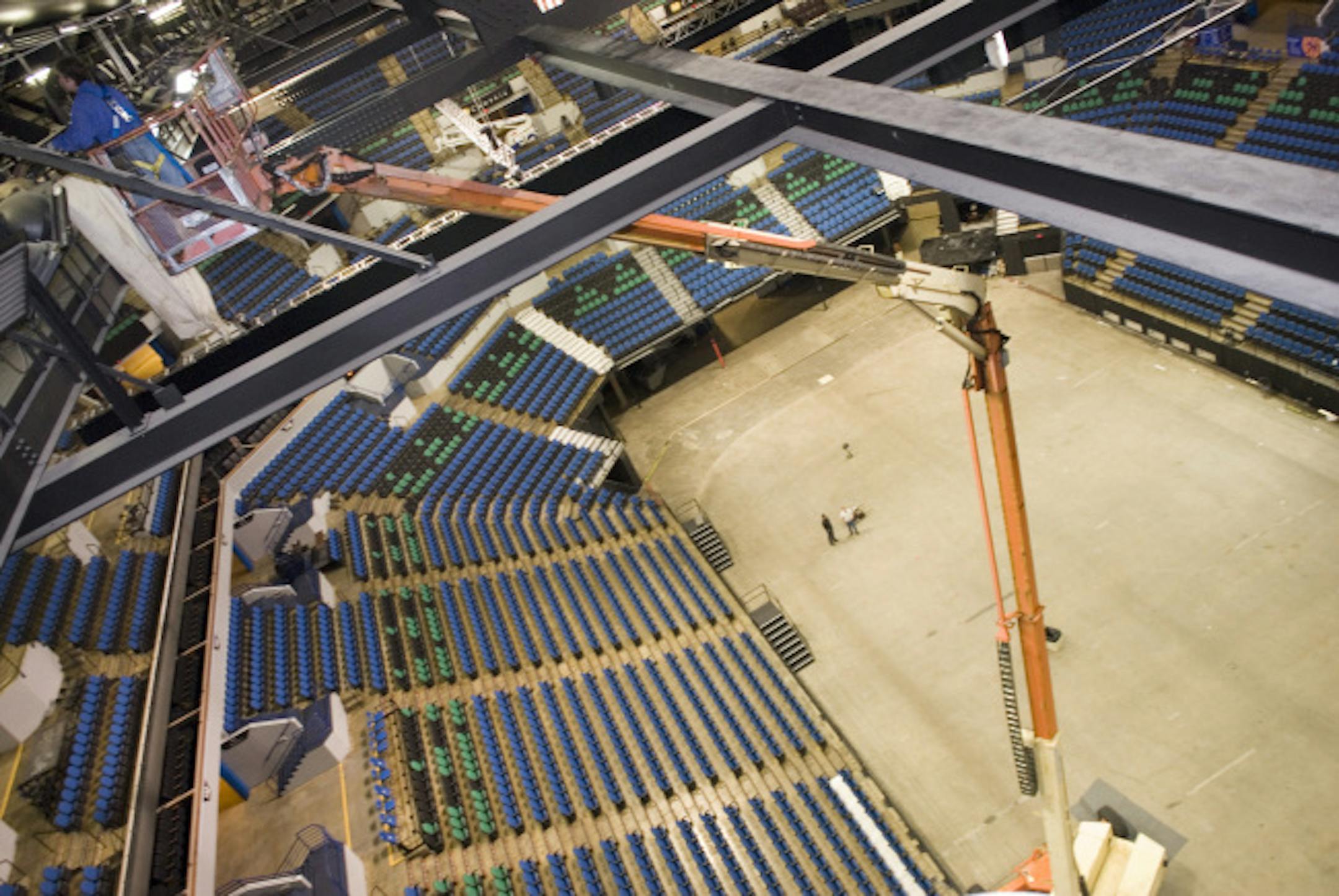 A local union crew works to install sound-absorbing material to improve the sound of the Target Center, in the upper rafters of the areana. Flyhouse, a rigging company from Chicago, is overseeing the installation. Flyhouse specialzes in installing things no other company wants to do throughout the States. In this Photo: David Drown, from the local union, works Friday morning to hang panels in the Target Center areana.