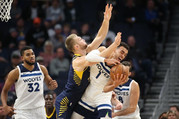 Indiana Pacers forward Domantas Sabonis (11) fouled Minnesota Timberwolves guard Tyus Jones (1) in the first half