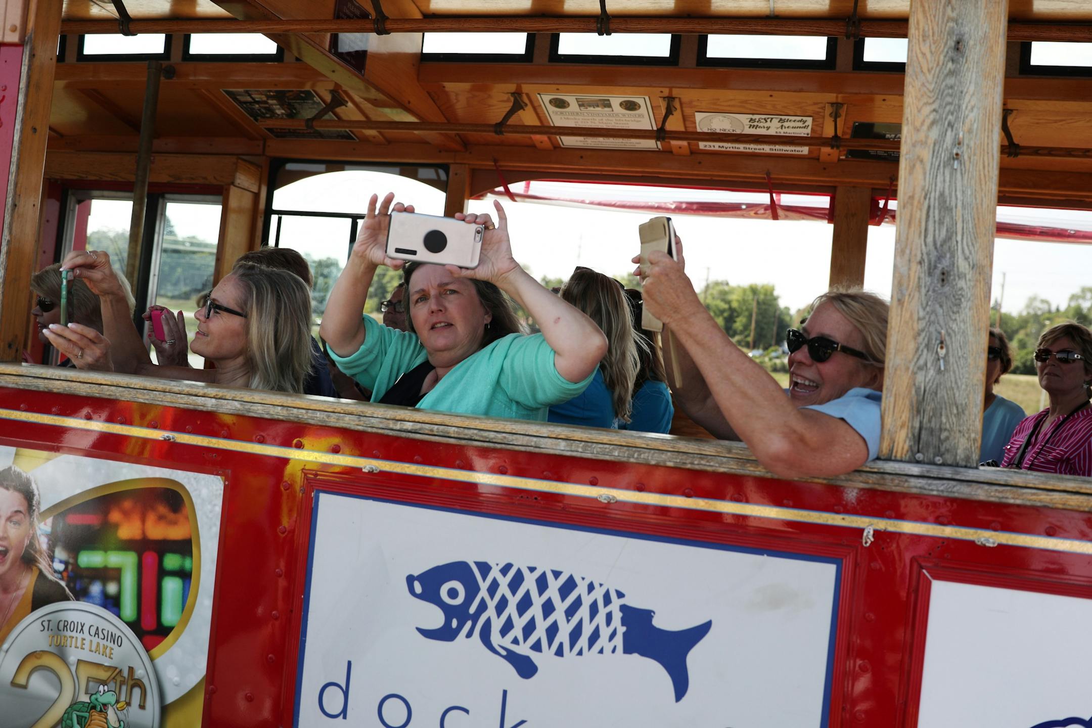 Ribbon-cutting ceremony attendees took photos with their phones as they rode a trolly back to their parked cars.