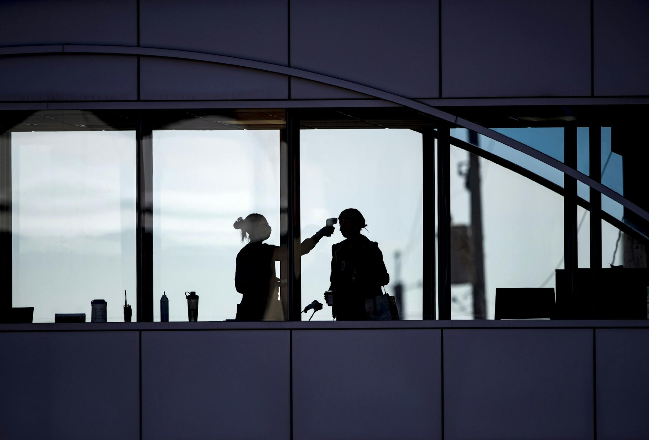 Healthcare workers took the temperature of every visitor of Essentia Health who crossed over a skywalk bridge from the adjoining parking deck in Duluth, MN on Friday.