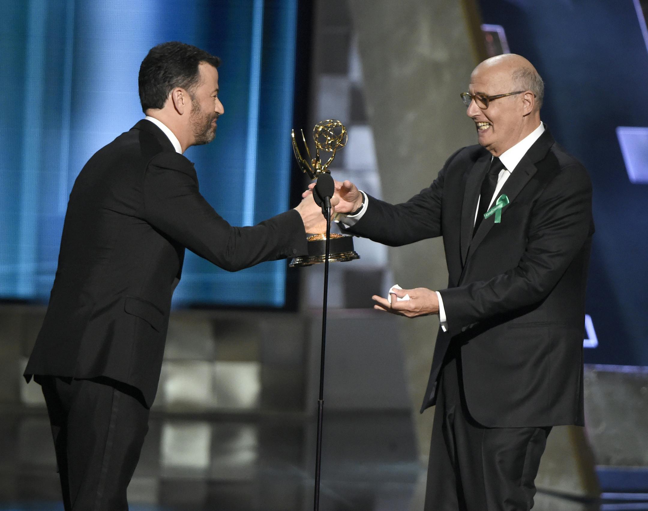 Jimmy Kimmel, left, presents the award for outstanding lead actor in a comedy series to Jeffrey Tambor for "Transparent" at the 67th Primetime Emmy Awards on Sunday, Sept. 20, 2015, at the Microsoft Theater in Los Angeles. (Photo by Chris Pizzello/Invision/AP)