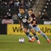 Minnesota United midfielder Hassani Dotson, front, moves the ball past Colorado Rapids defender Sam Vines during an MLS soccer match Saturday, May 8, 