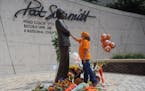 Teresa Olive, of Knoxville, Tenn., touches a statue of Pat Summitt as she pays her respects at the University of Tennessee, on Tuesday, June 28, 2016,