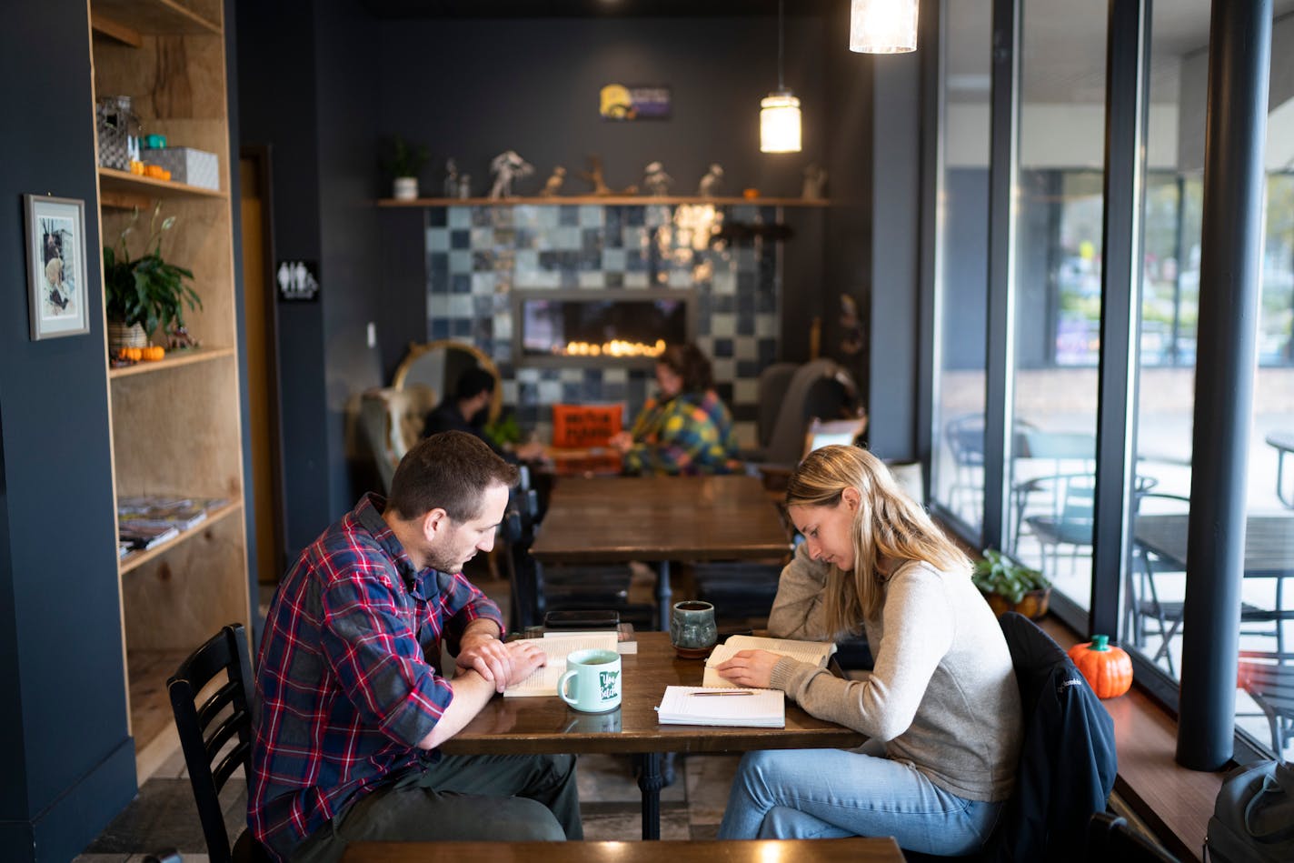 Matt Sieberg and Megan Sieberg read while having coffee at Makwa Coffee on Thursday, Oct. 13, 2022 in Roseville, Minn. "We are so happy we have a coffee shop in the neighborhood," Megan Sieberg said. Jamie Becker-Finn, an Ojibwe state legislator, lawyer and now craft coffee shop Makwa Coffee. ] RENEE JONES SCHNEIDER • renee.jones@startribune.com