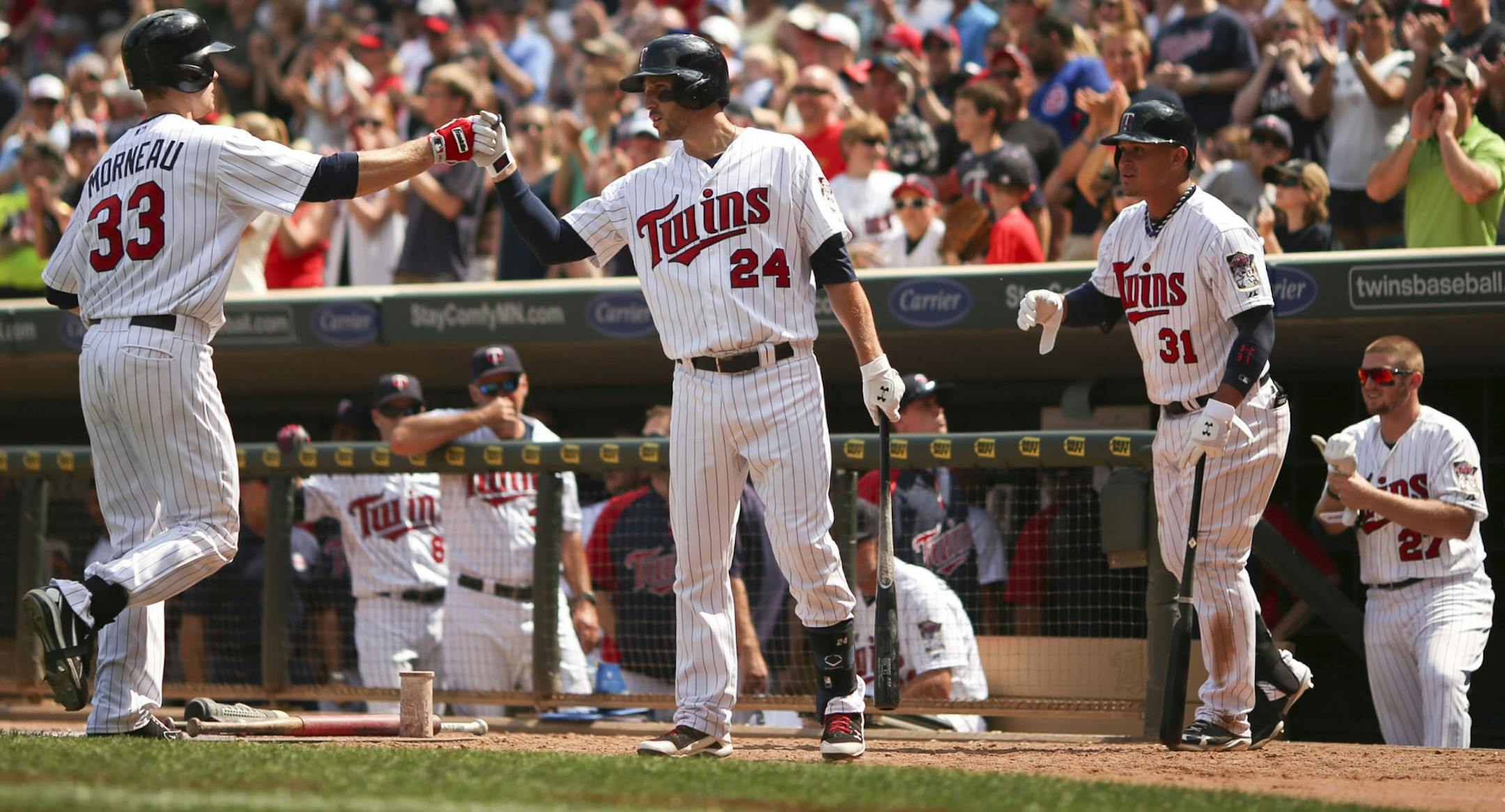 Justin Morneau was congratulated by Trevor Plouffe after a two-run homer in the seventh inning.