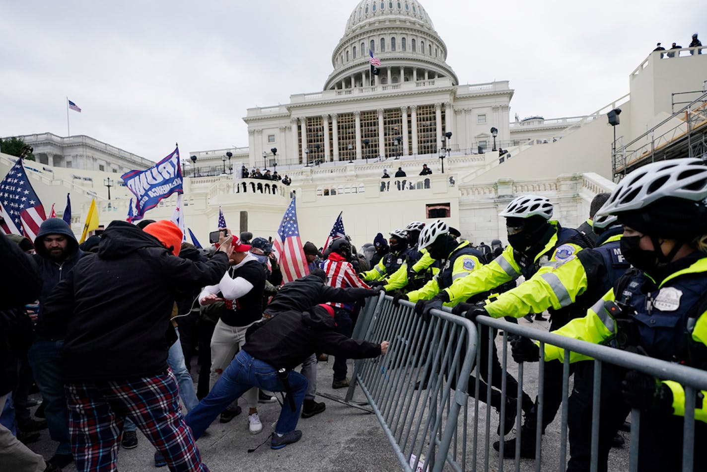 FILE - Insurrectionists loyal to President Donald Trump try to break through a police barrier, Wednesday, Jan. 6, 2021, at the Capitol in Washington. Top House and Senate leaders will present law enforcement officers who defended the U.S. Capitol on Jan. 6, 2021, with Congressional Gold Medals on Wednesday, Dec. 7, 2022, awarding them Congress's highest honor nearly two years after they fought with former President Donald Trump's supporters in a brutal and bloody attack. (AP Photo/Julio Cortez, File)