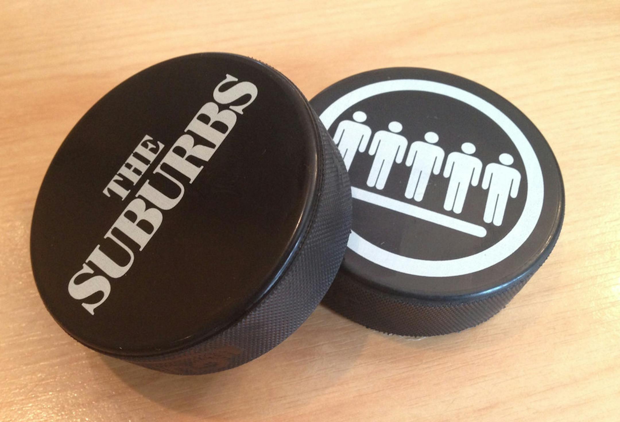 The Suburbs hockey pucks.
