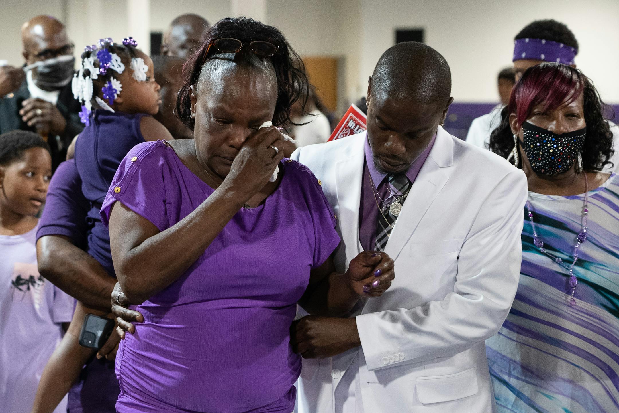 Leneal Frazier's mother Jacqueline and bother Orlando Frazier made their way behind the casket.