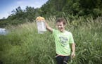 Josh Baker was more than excited to show that he had found a container of tape during a geocaching hike at the Lowry Nature Center during an outdoor a