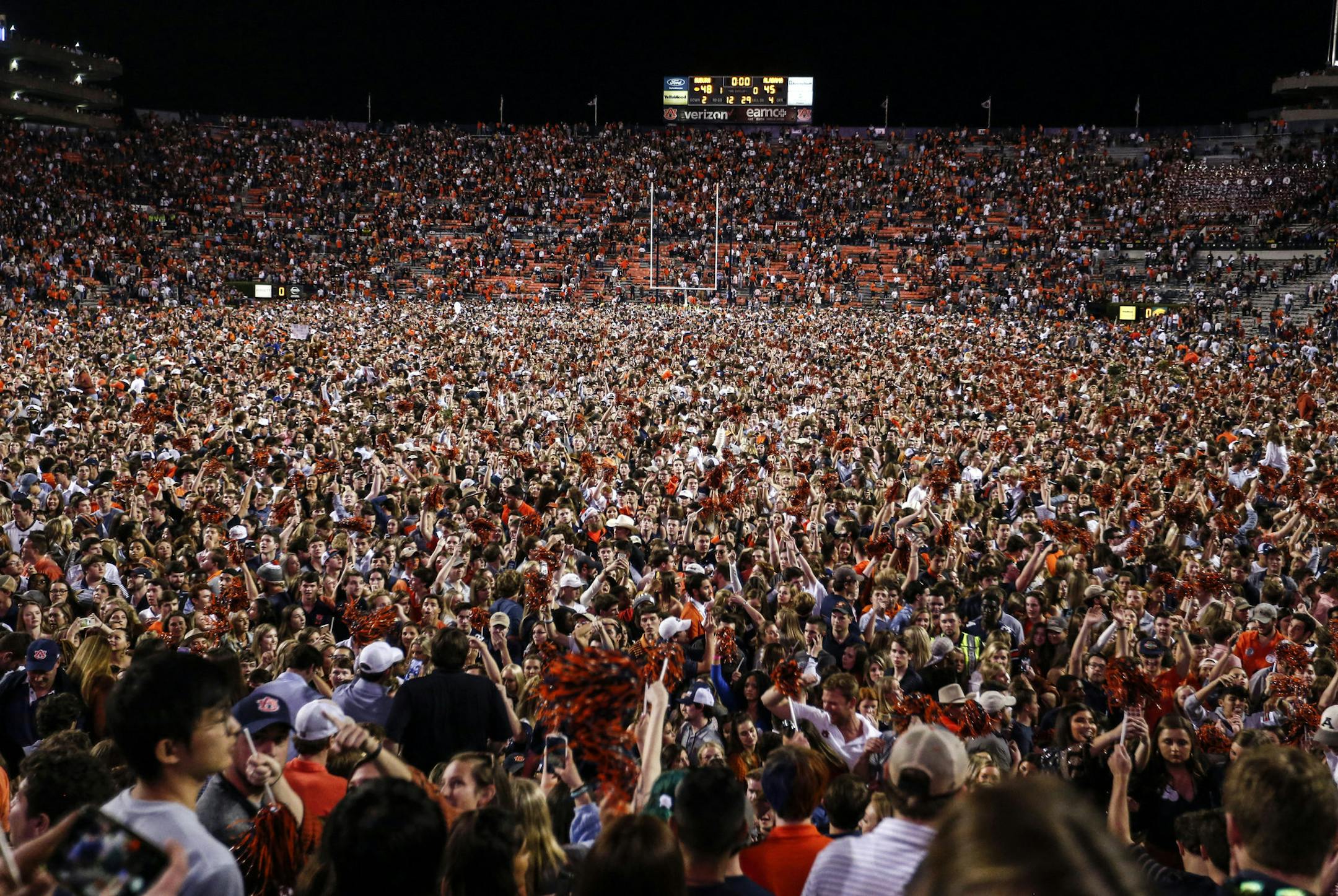 Auburn fans storm the field after they defeated Alabama 48-45 in an NCAA college football game Saturday, Nov. 30, 2019, in Auburn, Ala. (AP Photo/Butch Dill)