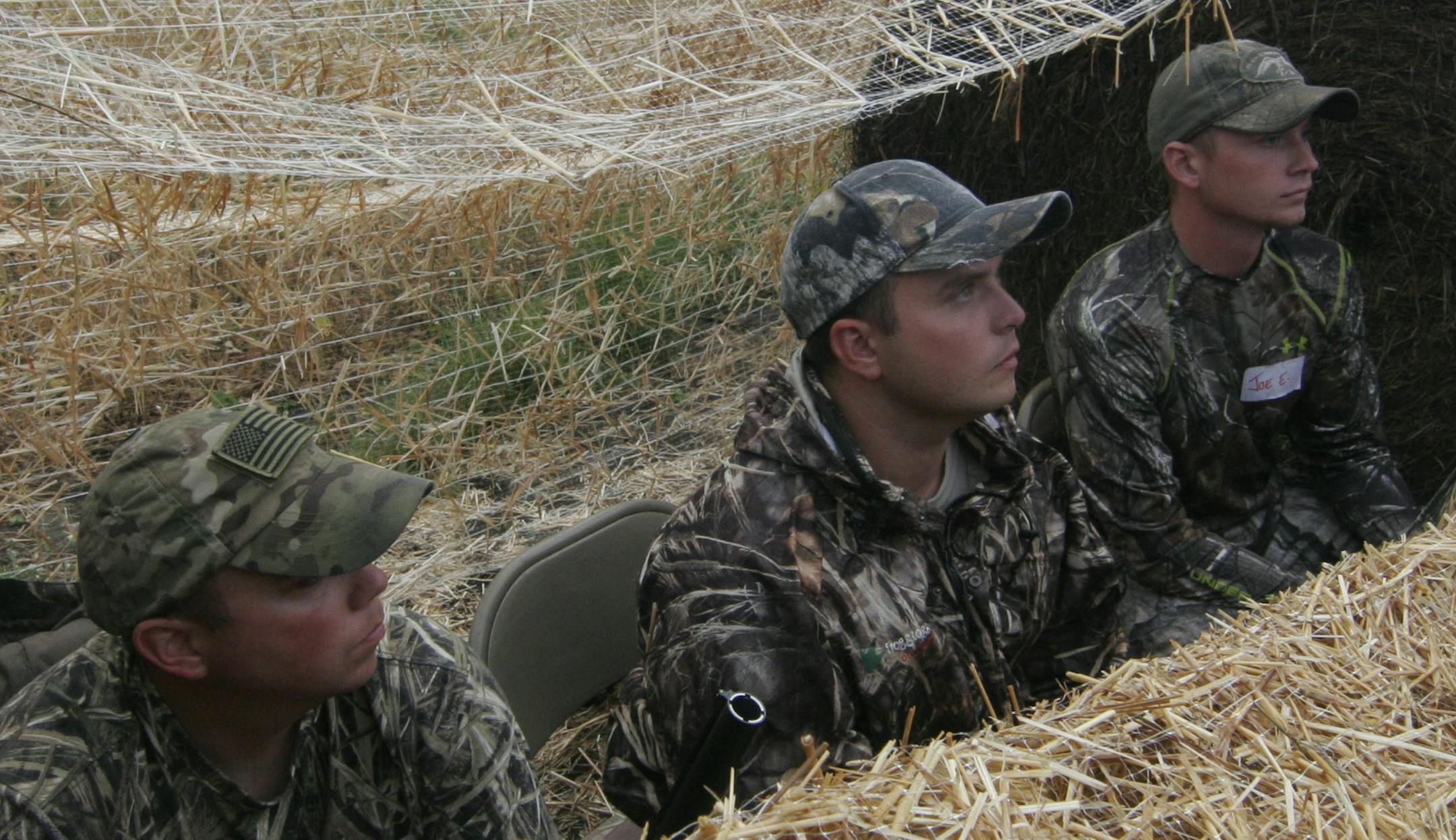 Joe Hill, 30, of Cottage Grove, left, Dylan Grimes, 20, of Mahtomedi, center, and Joe Ekhaml, 21, of Mahtomedi, all members of the Minnesota Army National Guard, scanned the sky for Canada geese.