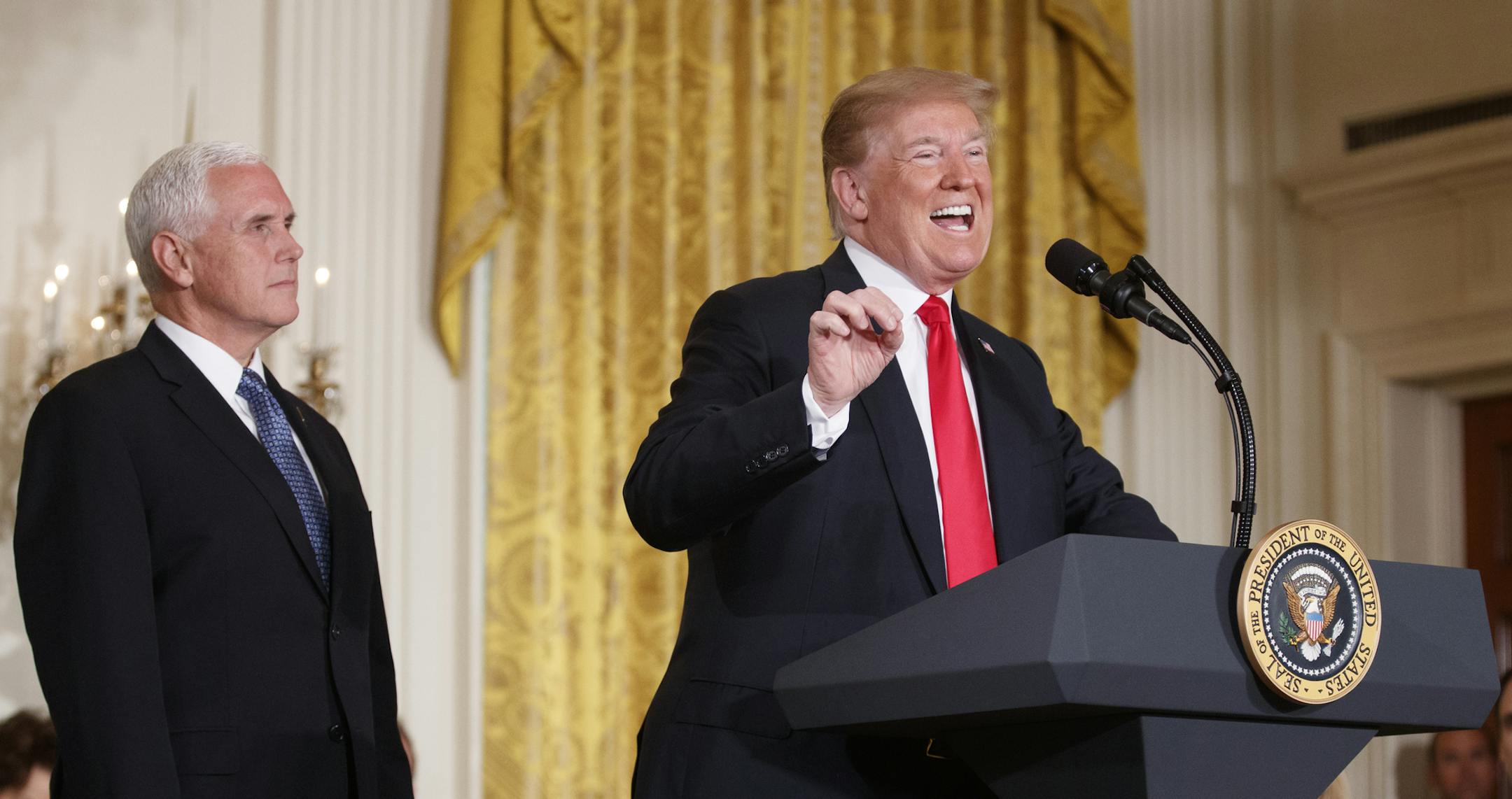 President Donald Trump, with Vice President Mike Pence nearby, speaks during a meeting of the National Space Council in the East Room of the White House, in Washington, June 18, 2018. At the event, Trump remained resistant Monday in the face of growing public outcry over his administrationís policy of separating children from their parents at the border, repeating the false assertion that Democrats were the ones to blame for it, and suggesting that criminals ó not parents ó were t