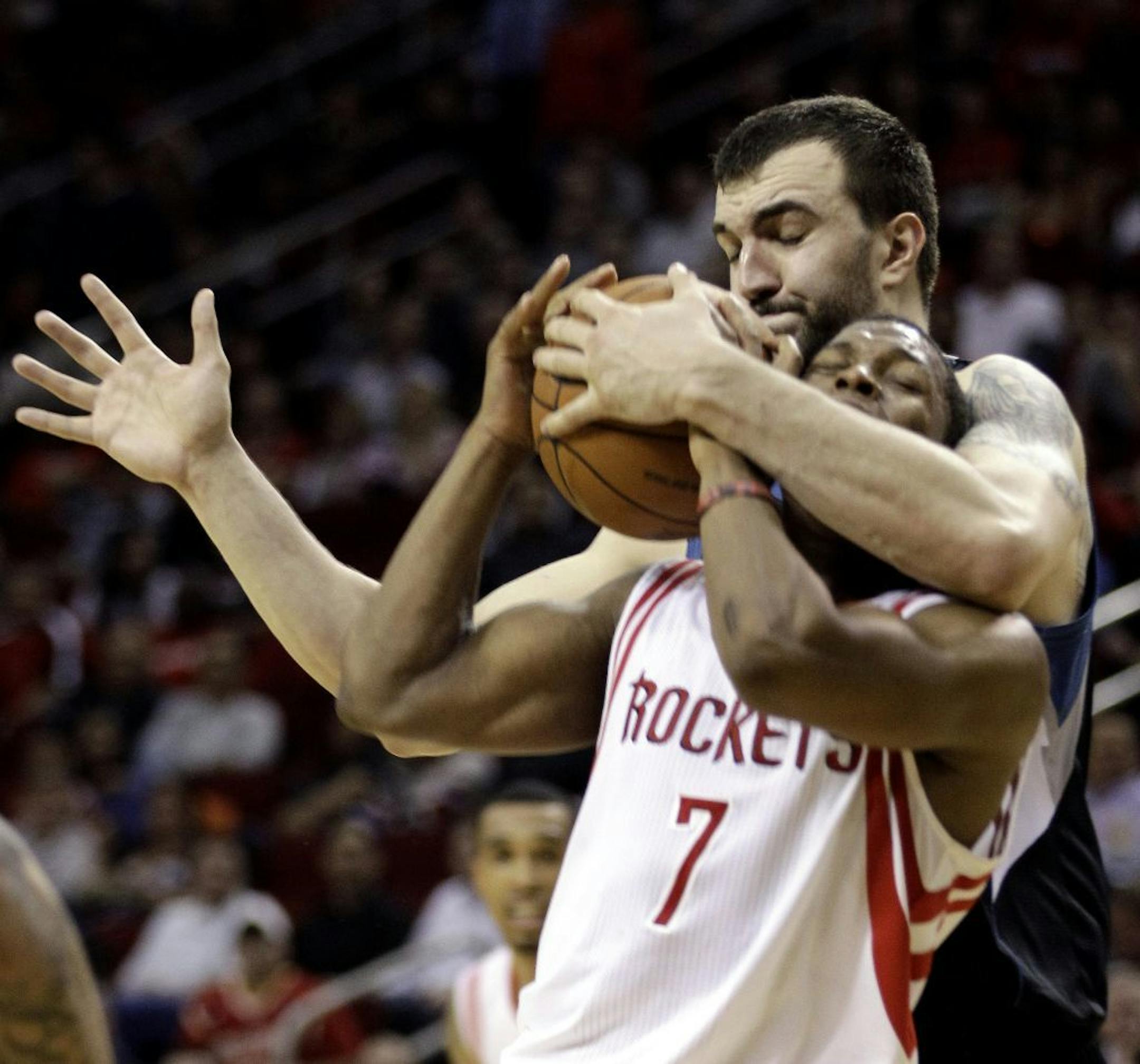 Minnesota Timberwolves' Nikola Pekovic, rear, steals the ball from Houston Rockets' Kyle Lowry (7) during the fourth quarter of an NBA basketball game on Friday, Feb. 17, 2012, in Houston. The Timberwolves defeated the Rockets 111-98.