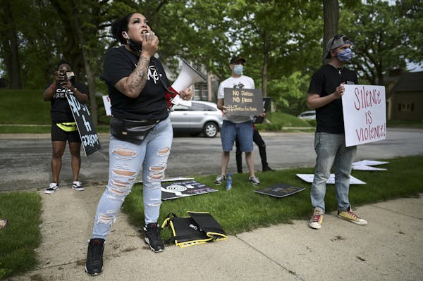 Ashley Quinones, widow of Brian Quinones, who was killed by Edina and Richfield police in 2019, protested outside Hennepin County Attorney Mike Freema