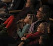Karine Watne sat in the front row at Orchestra Hall with her twin daughters, Khloe, on her lap, and Kamille, 7. ] JEFF WHEELER &#xef; jeff.wheeler@sta
