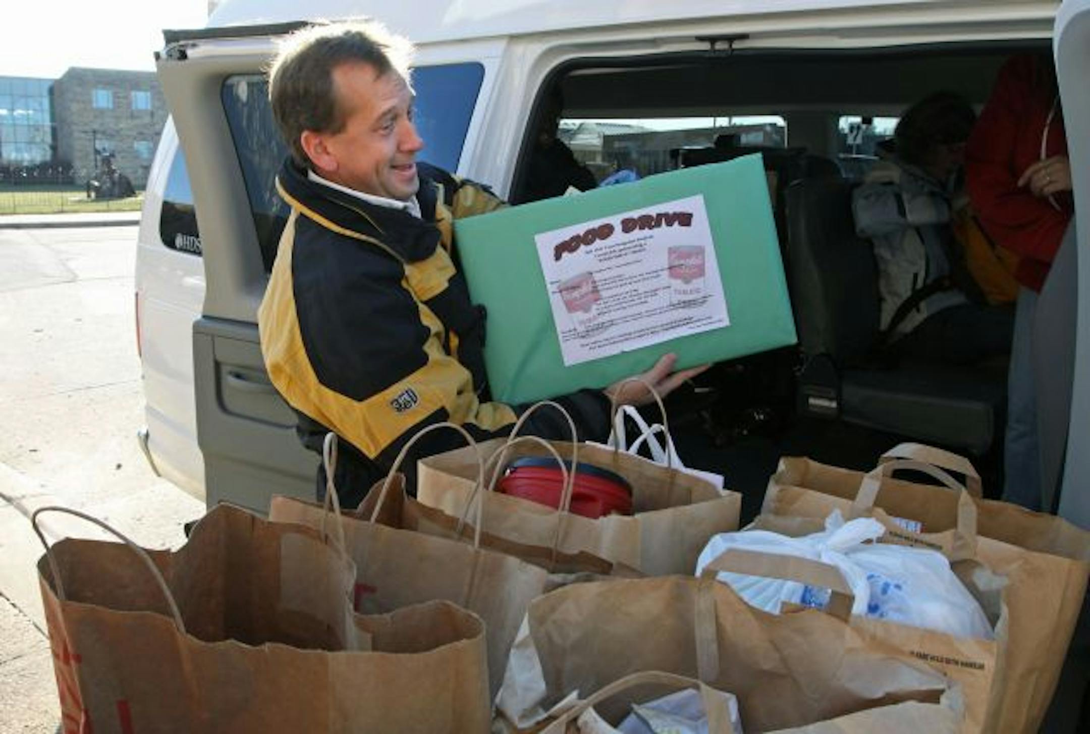Jason Norring, a teacher in Rosemount, loaded some of the 165 pounds of food collected by TESA program students during a food drive for the Hastings Family Service food shelf.