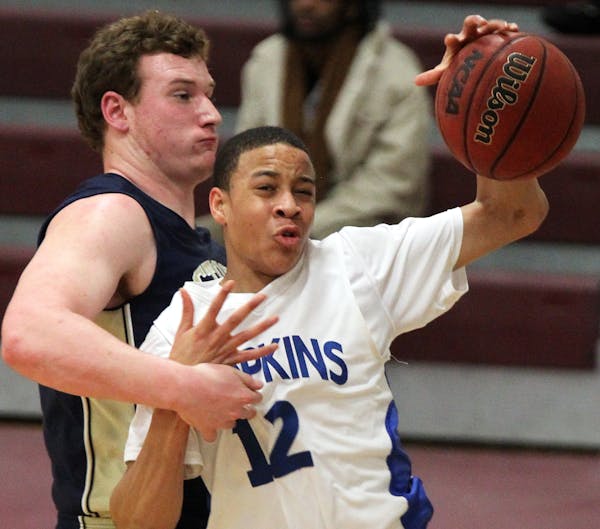 Prep boys Holiday Basketball Tournament at Augsburg College. Hopkins guard Amir Coffey (12) attempted to drive around the defense of Chanhassen'sFrank