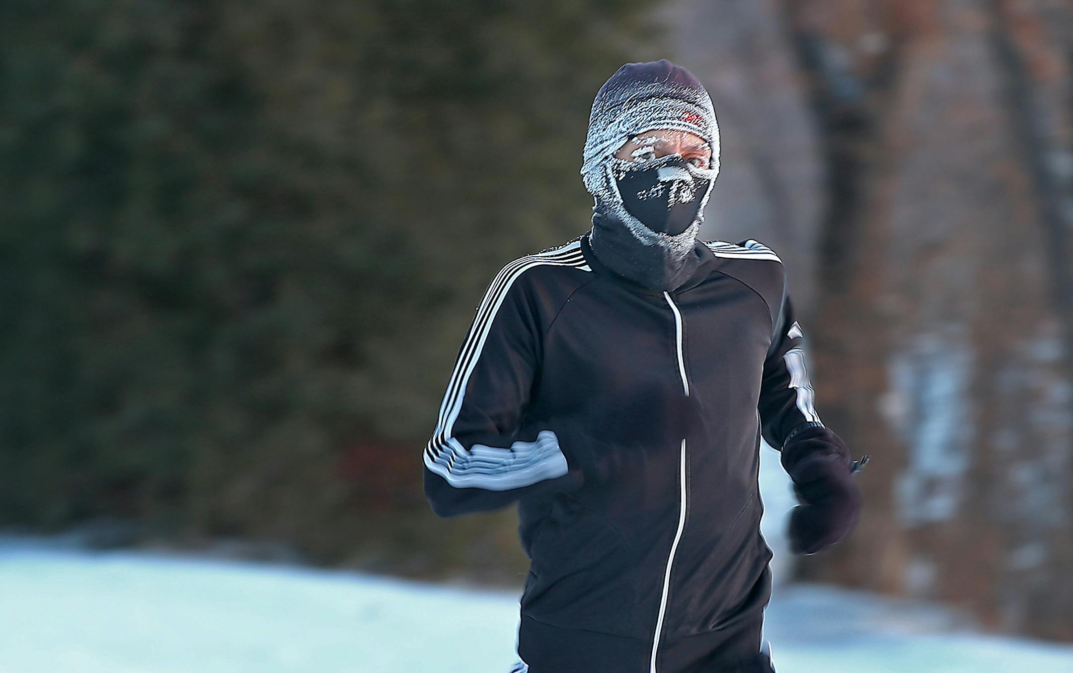 A runner (who did not want to be identified) braved a -30 wind chill advisory as he ran around Lake Calhoun, Wednesday, January 7, 2015 in Minneapolis, MN.