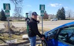 Bill Gehn, known on Plugshare as "The Ubiquitous Electric Bill" checks out a charger in Edina.