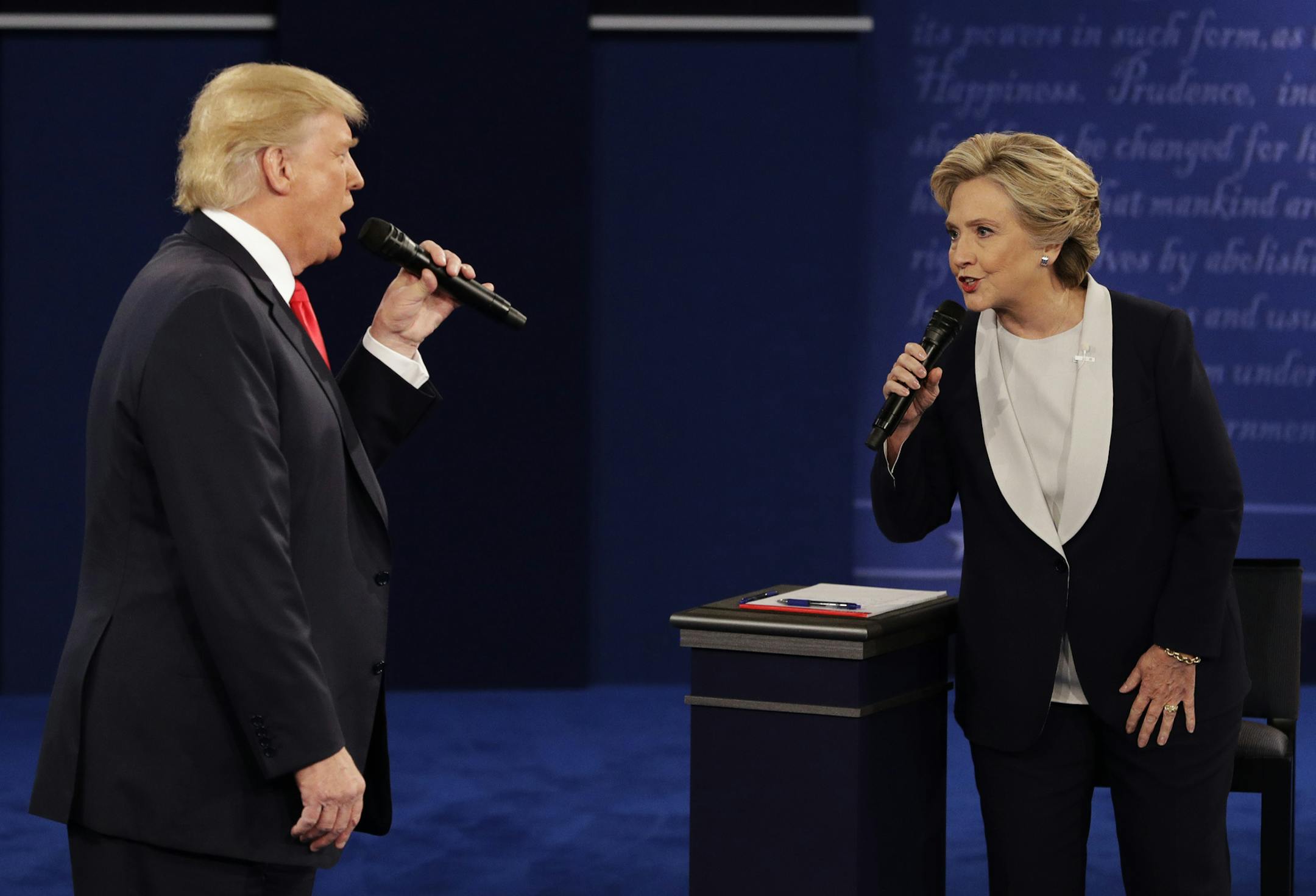 Republican presidential nominee Donald Trump and Democratic presidential nominee Hillary Clinton speak during the second presidential debate at Washington University in St. Louis, Sunday, Oct. 9, 2016. (AP Photo/John Locher)