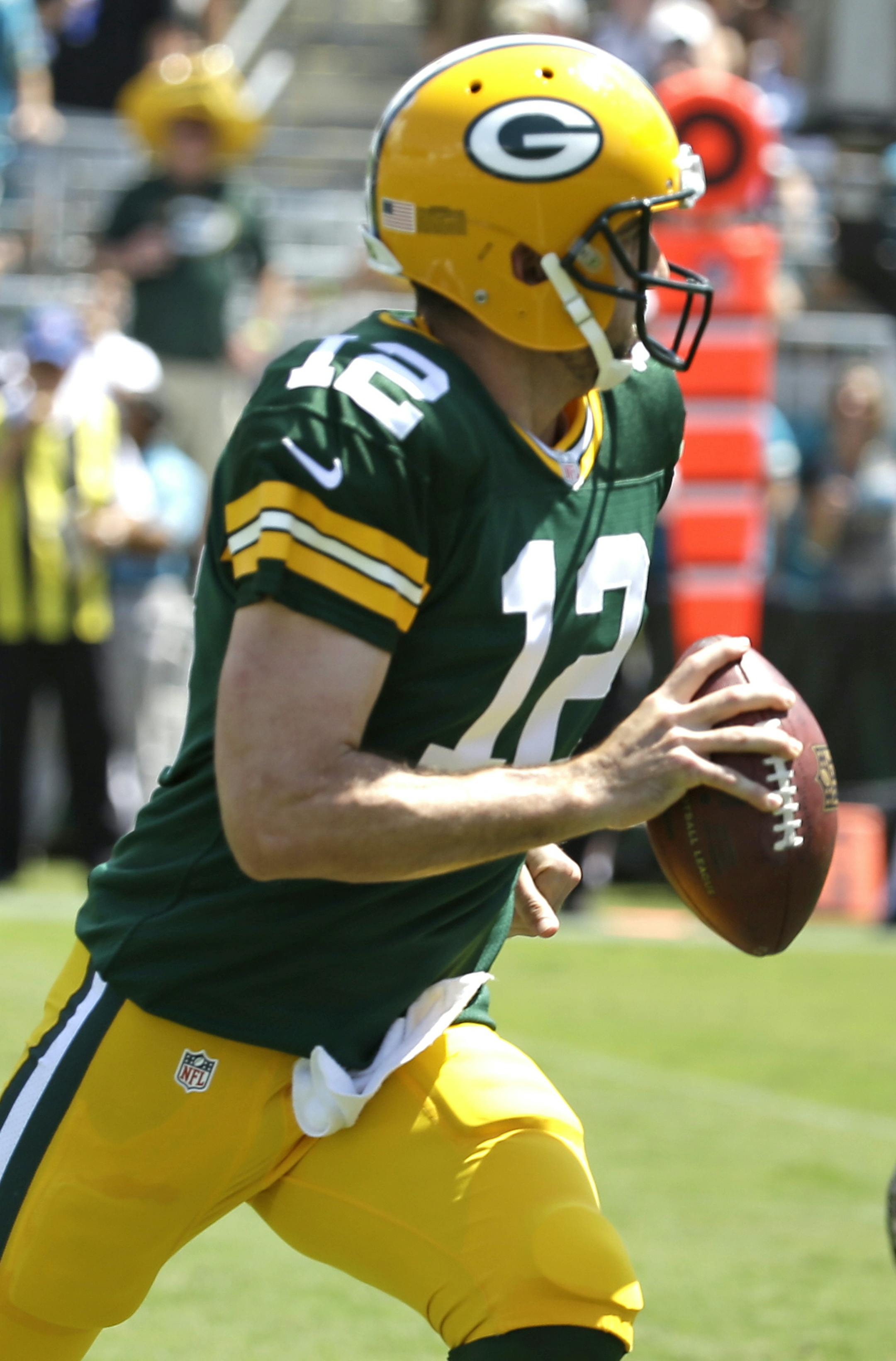 Green Bay Packers quarterback Aaron Rodgers (12) runs for a 6-yard touchdown past Jacksonville Jaguars defensive tackle Roy Miller (97) during the first half of an NFL football game in Jacksonville, Fla., Sunday, Sept. 11, 2016.(AP Photo/John Raoux)