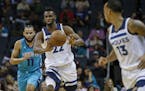 Minnesota Timberwolves forward Andrew Wiggins, center, passes to guard Shabazz Napier ahead of Charlotte Hornets forward Cody Martin in the second hal