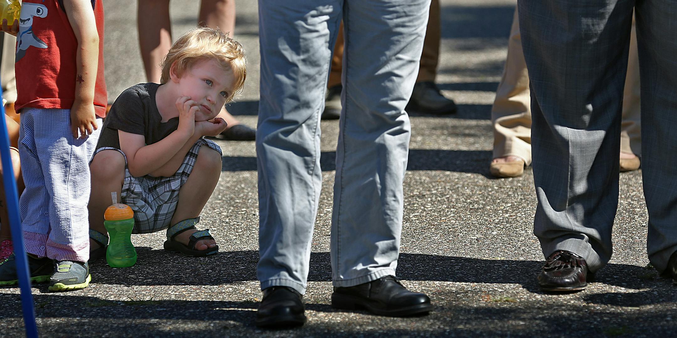 Kainalu Lazarus, 3, listened to speakers as they addressed the group.