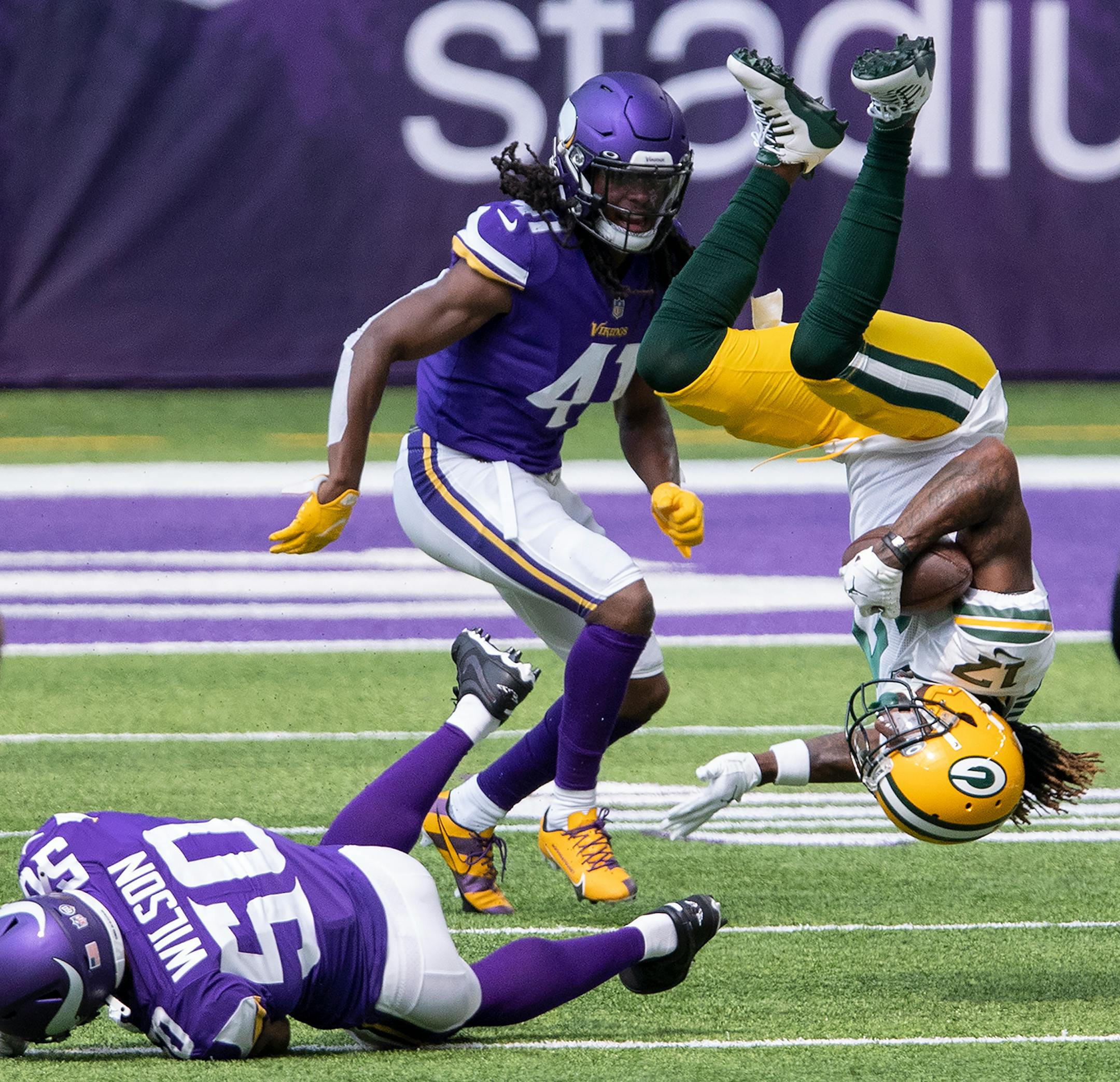 Green Bay Packers wide receiver Davante Adams jumped over Minnesota Vikings linebacker Eric Wilson in the first quarter.