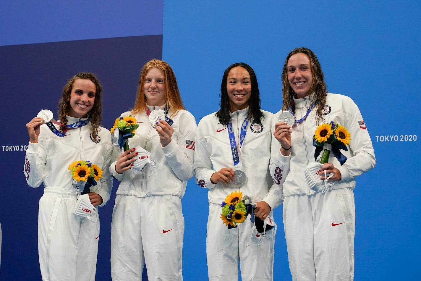 The United States' women's 4x100-meter medley relay team, Regan Smith, Lydia Jacoby, Torri Huske and Abbey Weitzeil, celebrates at the podium after winning the silver medal