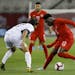 Canada midfielder Alphonso Davies (12) dribbles against Cuba defender Jean Carlos Rodriguez (17) during the first half of a CONCACAF Nations League so