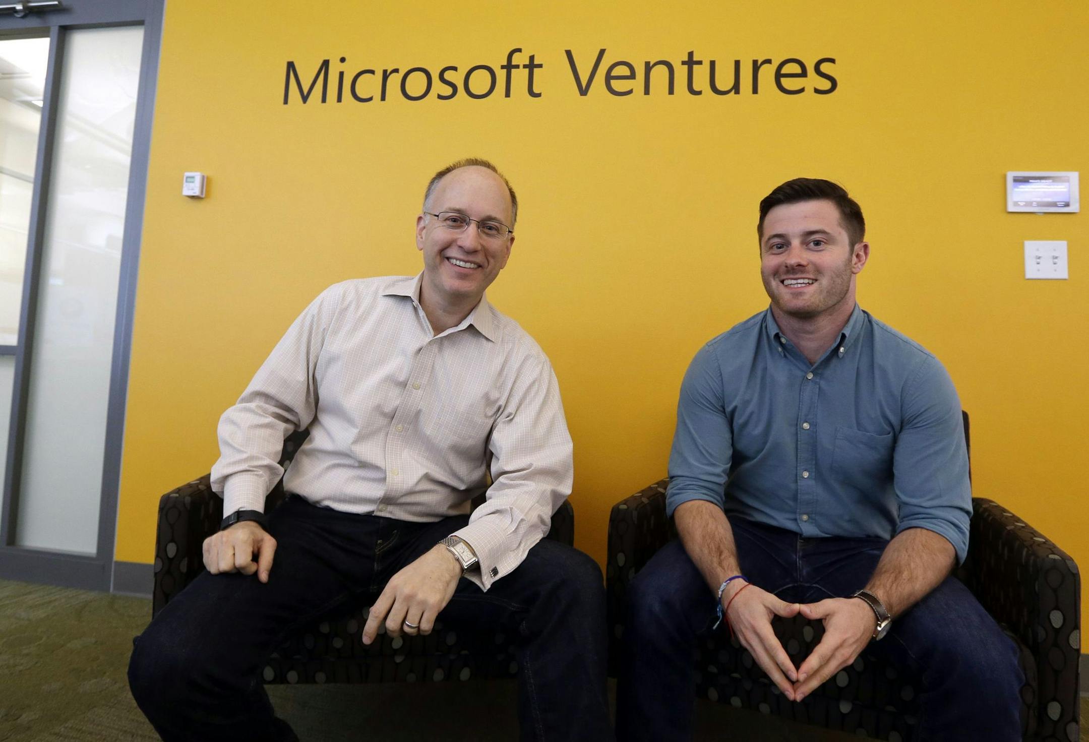 In this May 4, 2015 photo, Mark Hirsch, owner of Creative Worx, left, and Dan Bloom, owner of Slope, pose for photos in the offices of Microsoft Ventures in Seattle. As part the Ventures program, Hirsch and Bloom get work space, technical advice and feedback from Microsoft employees. The company has given the startups $25,000 each. (AP Photo/Elaine Thompson) ORG XMIT: NYBZ131