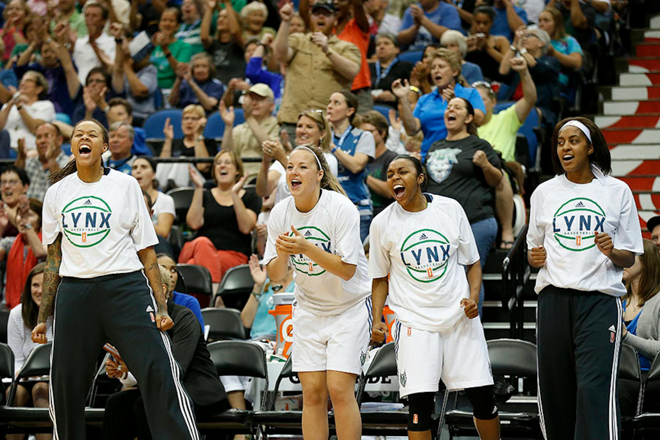 Minnesota Lynx players, from left Seimone Augustus, Tricia Liston, Renee Montgomery and Shae Kelley cheer on their team during the second half of a WNBA basketball game against the San Antonio Stars, Tuesday, Aug. 11, 2015, in Minneapolis. The Lynx won 83-76.