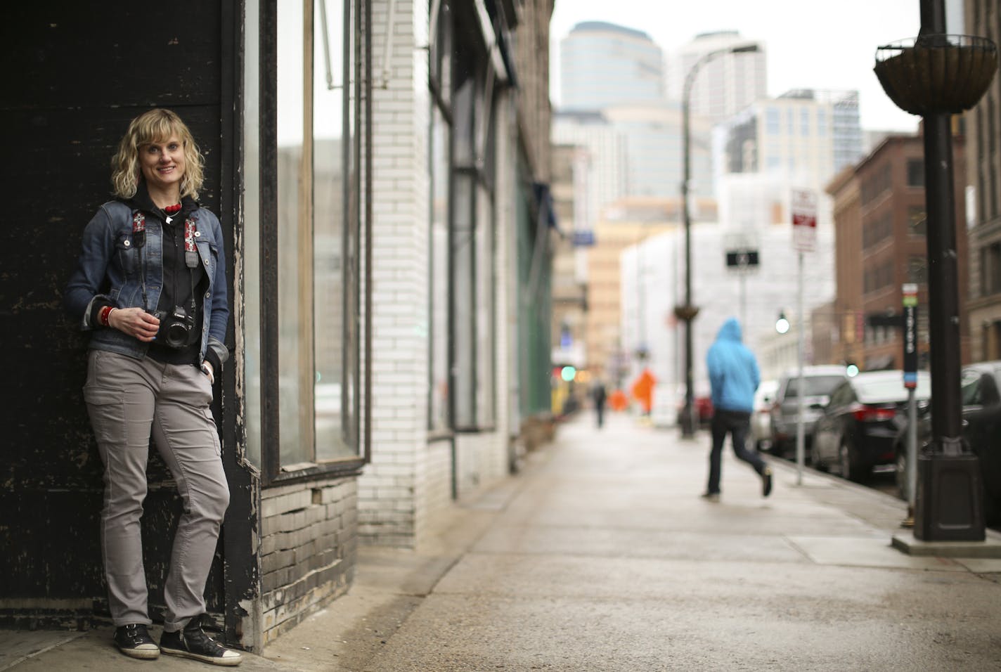 Stephanie Glaros on the street in the Warehouse District. She stops people on the street, interviews them and takes a portrait.