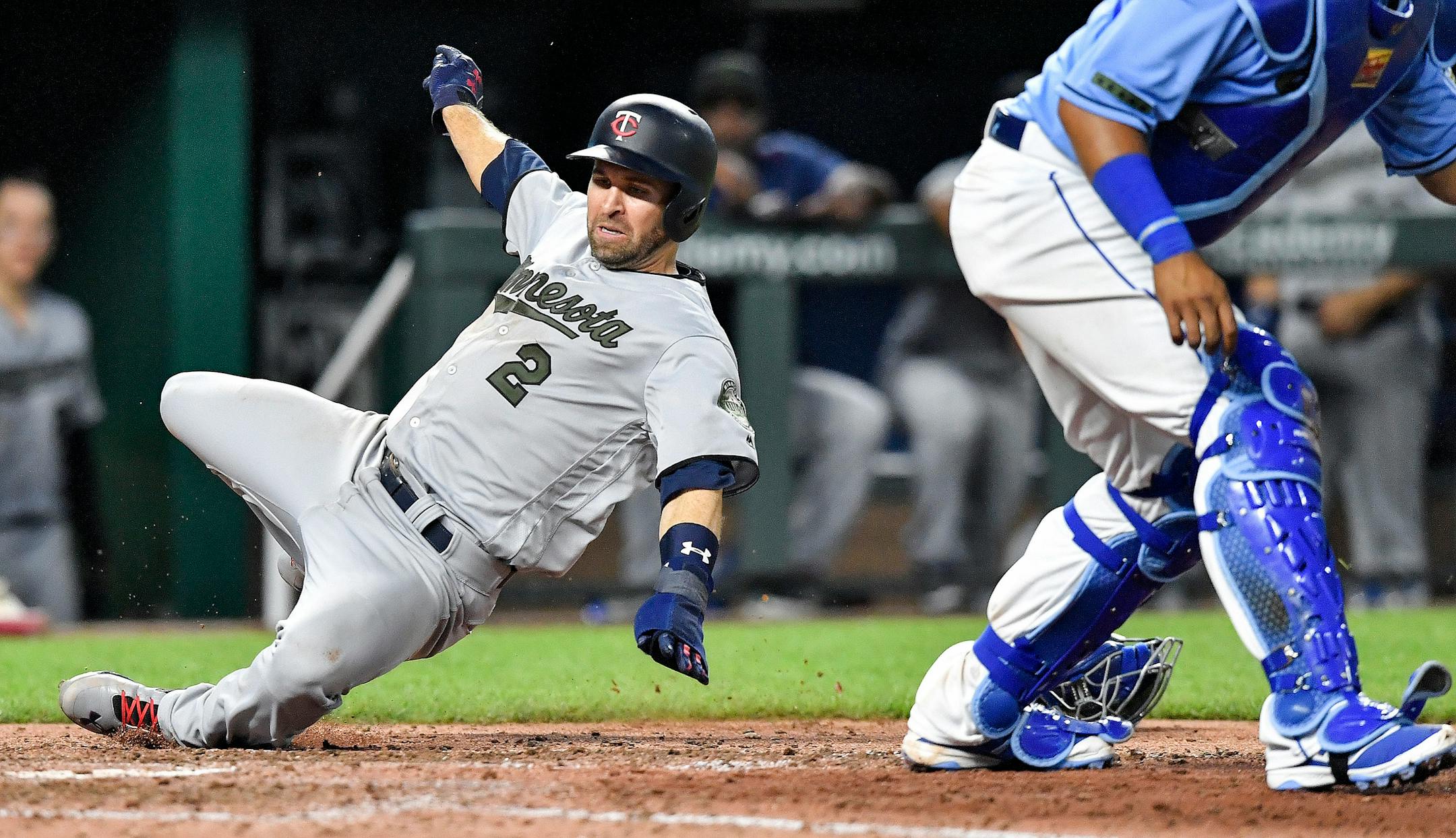 The Twins' Brian Dozier scored behind Royals catcher Salvador Perez on a three-run double by Eddie Rosario in the eighth inning Monday.