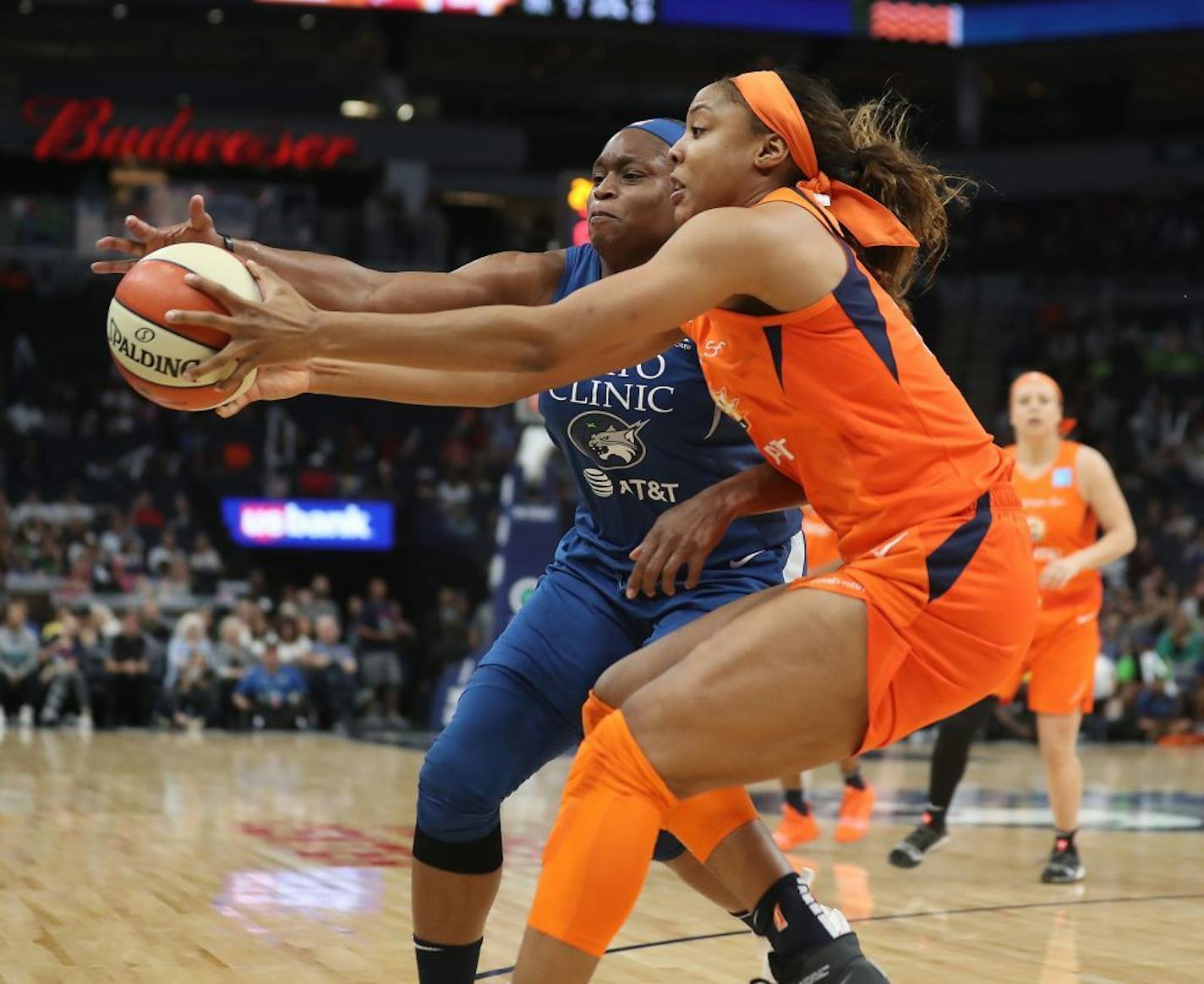 The Connecticut Sun's Kristine Anigwe, front, and the Lynx's Karima Christmas-Kelly chase after a loose ball during the second half of a game last season at Target Center.