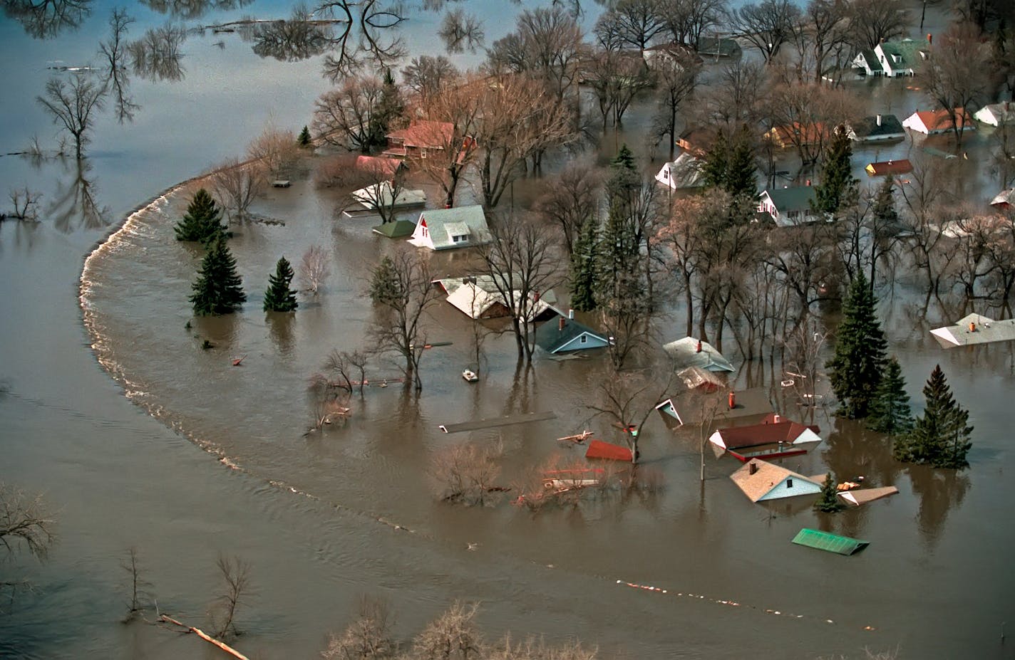 By the time the Red slipped back into its banks in late May, the record flood of 1997 had done nearly $2 billion in damage. All told, nearly 1,500 houses in Grand Forks and neighboring East Grand Forks, Minn. were destroyed; the better part of four neighborhoods were ruined and later razed. Eleven buildings in downtown Grand Forks were gutted by fire that broke out after the cities were evacuated. ] BRIAN PETERSON ¥ brian.peterson@startribune.com Grand Forks, ND 03/31/2017