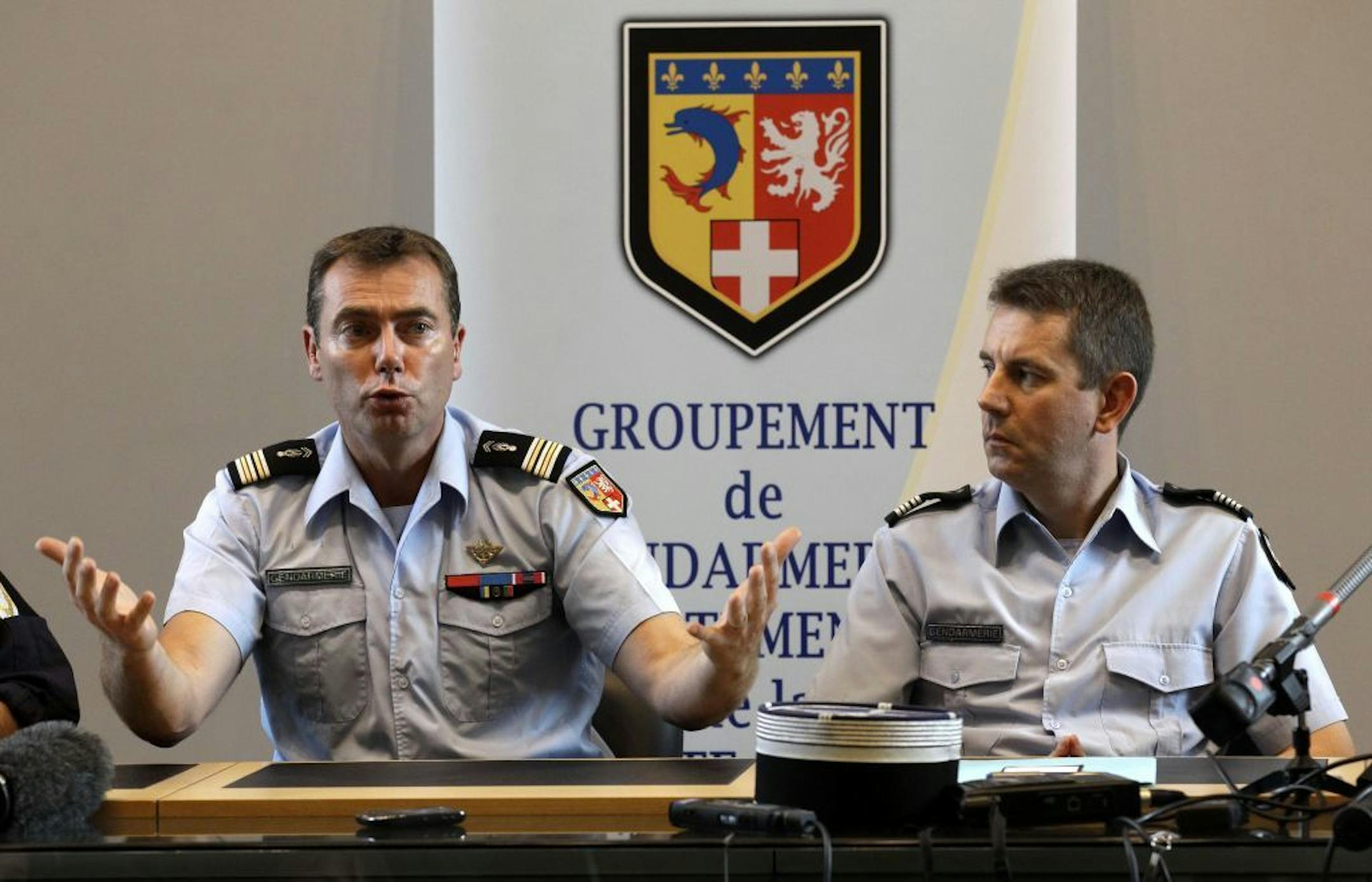 French Gendarme Lt. Col. Benoit Vinneman, left, answers a question during a news conference in Annecy, France, Thursday Sept. 6, 2012. French investigators said Friday they still don�t know the reason for the killings of what appears to be a family of British vacationers found in a car in the French Alps.